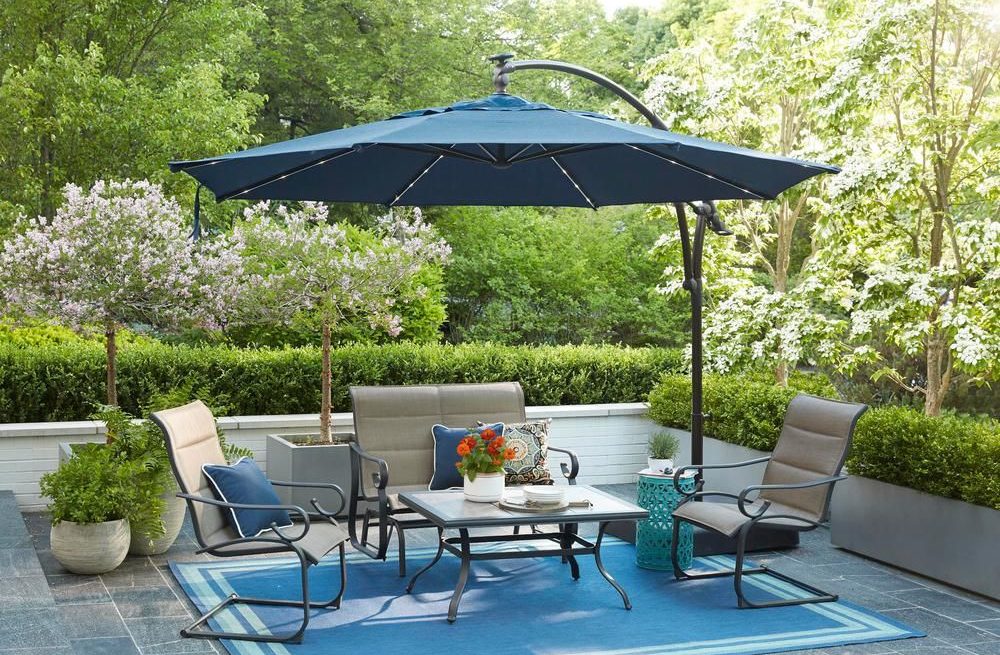 Blue cantiveler umbrella over metal chairs and tables