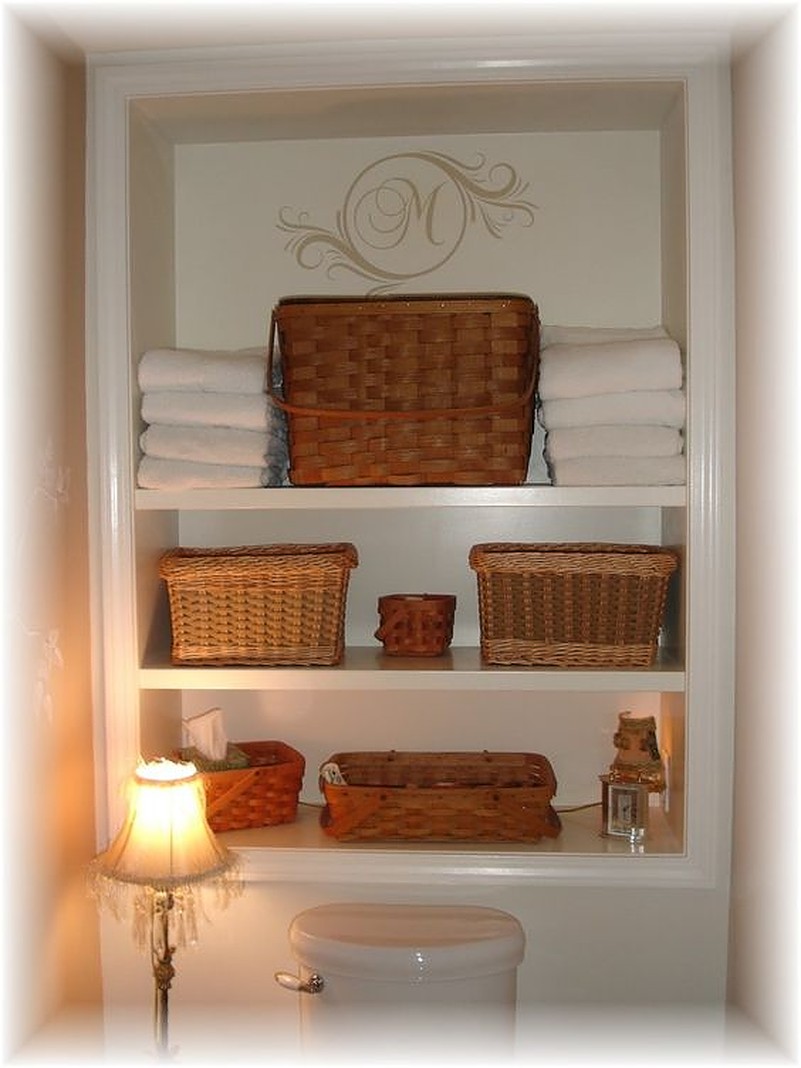 Brown baskets on white shelf above toilet