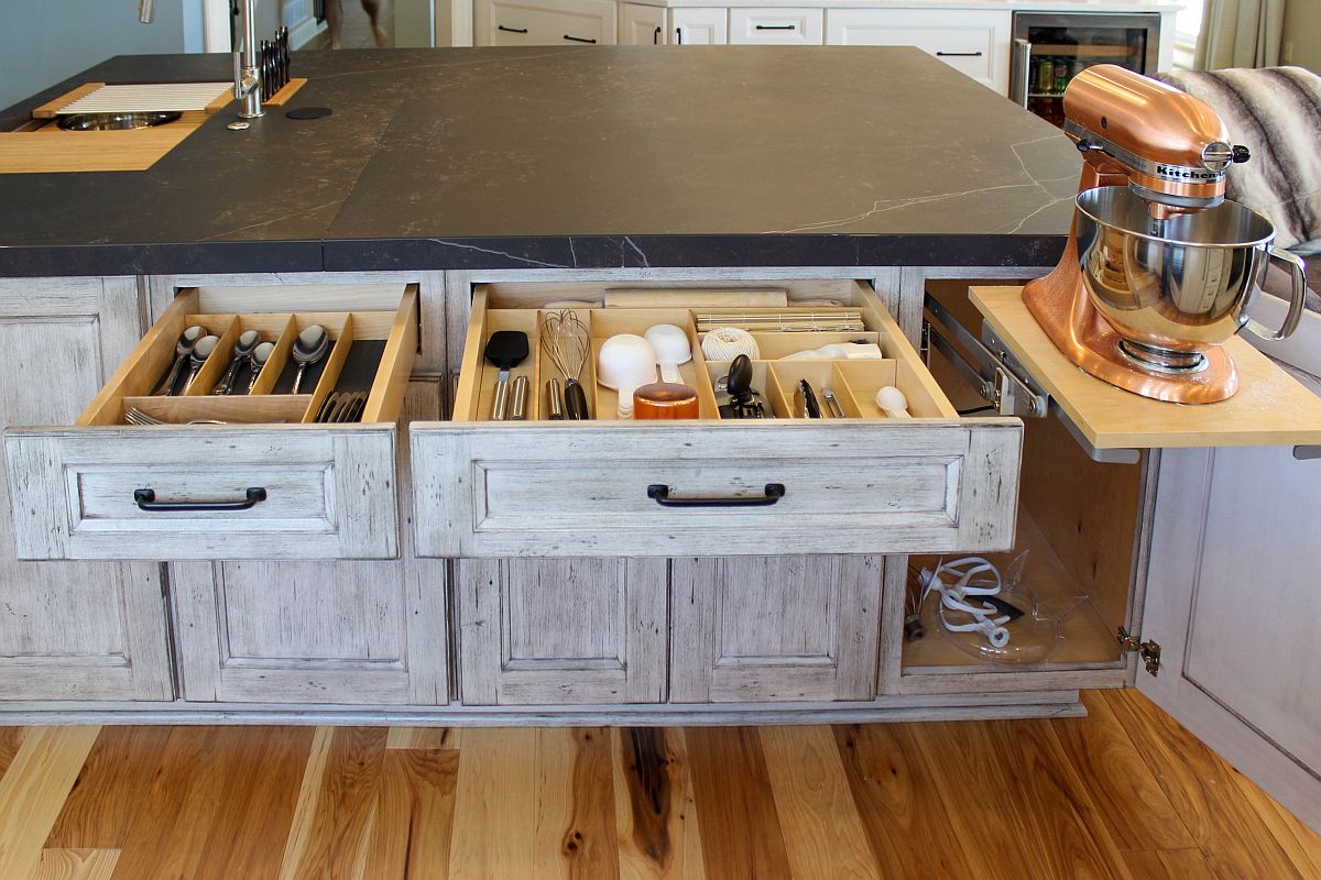 Clever custom storage solutions for the rustic kitchen in gray and white with wooden cabinets and stone countertops