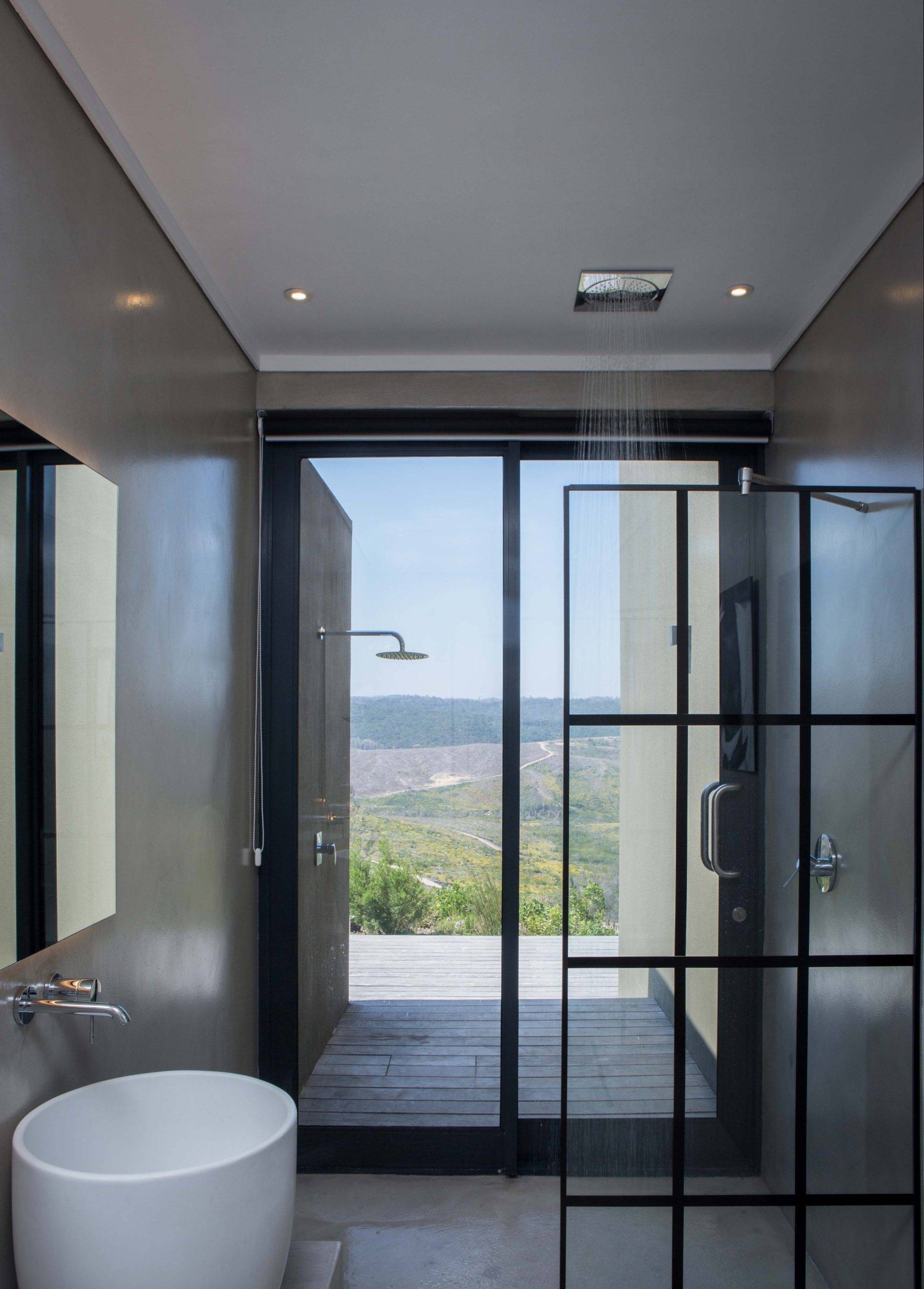 Exquisite contemporary bathroom in gray and white with glass partition