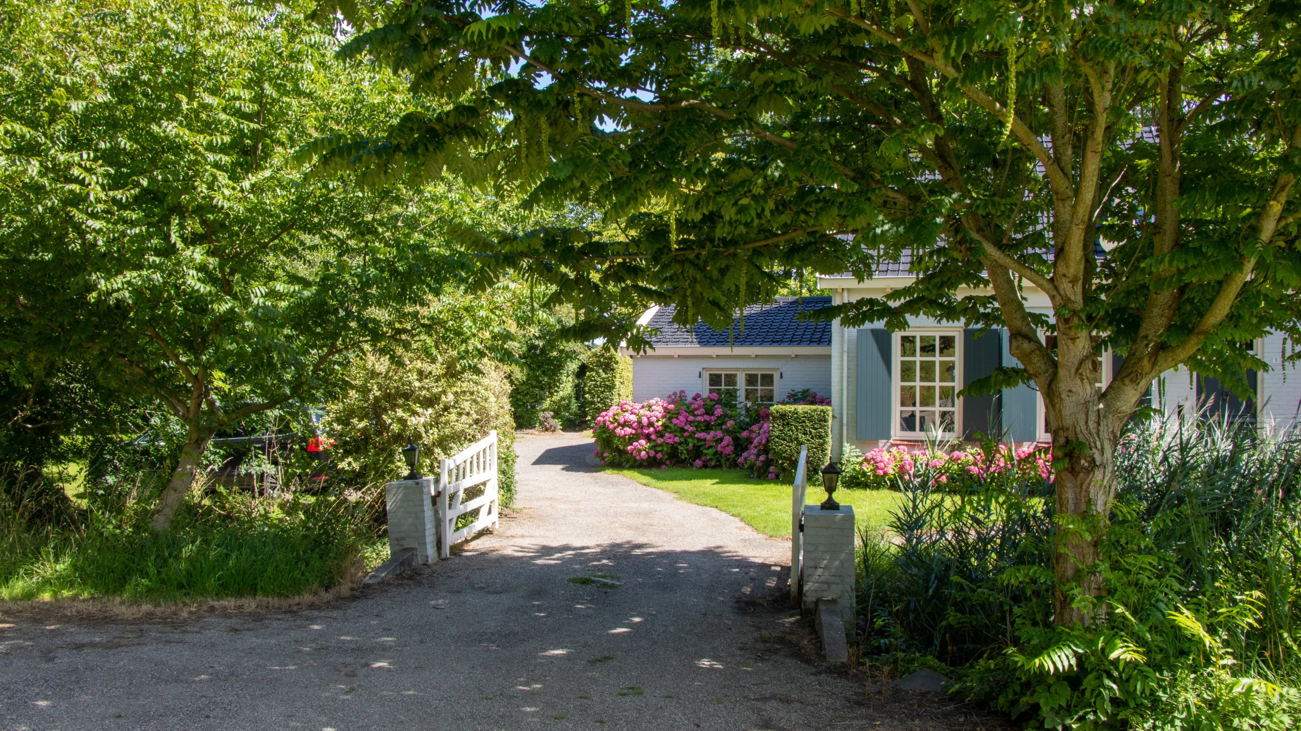 Exterior of house with unpaved driveway