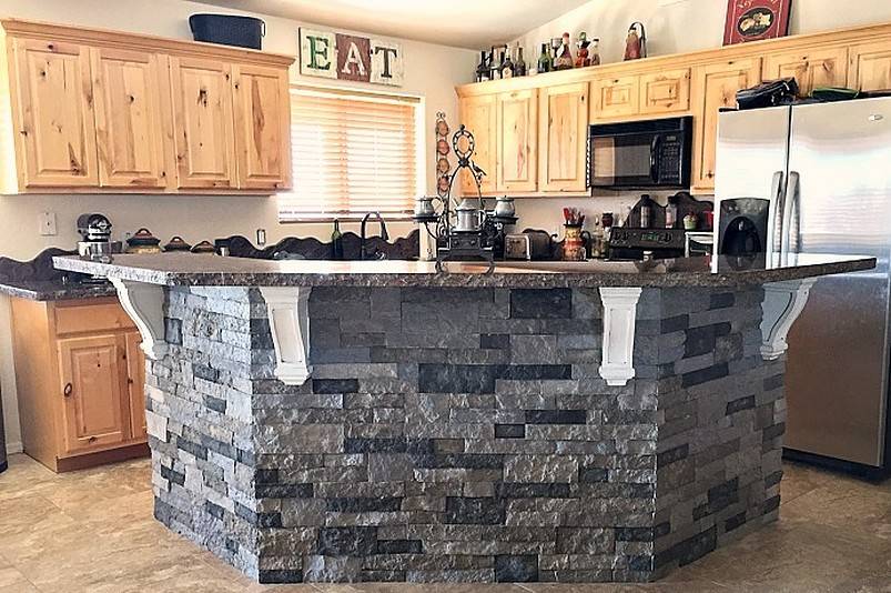 Gray kitchen island with granite and stones