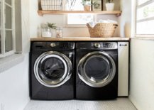 Laundry room with black washer and dryer and penny tile floor design