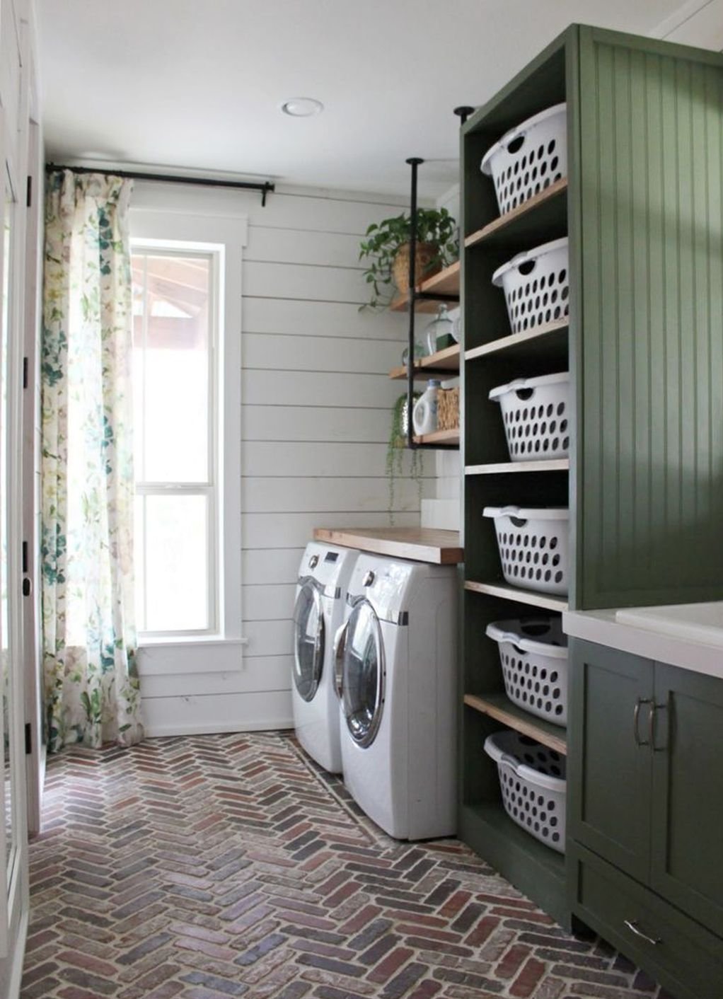 Laundry room with herringbone flooring