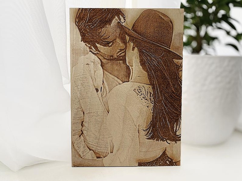 Man kissing a woman in wood photo