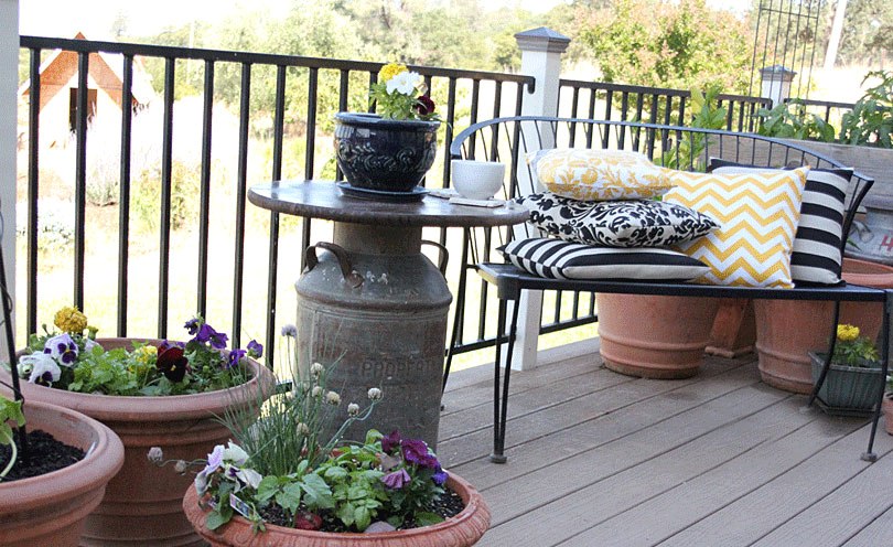 milk can side table on porch