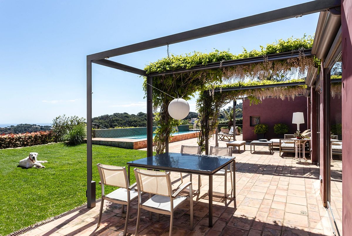 Minimal-pergola-frame-is-draped-with-greenery-in-an-organic-fashion-50398