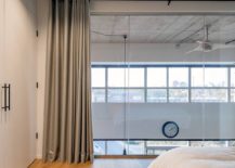 Modern-bedroom-with-wooden-floor-concrete-ceiling-and-gray-drapes-29996-217x155