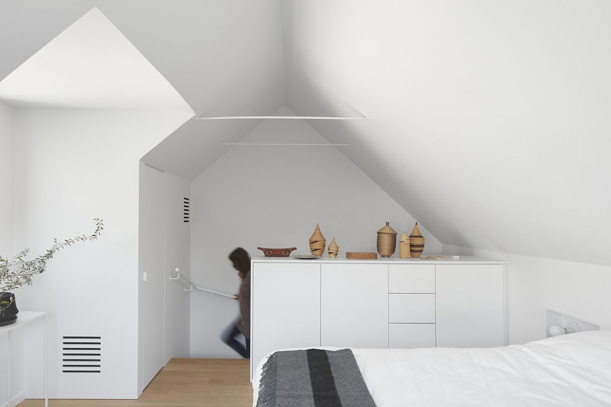 Modern minimal bedroom in white on the upper level of the home