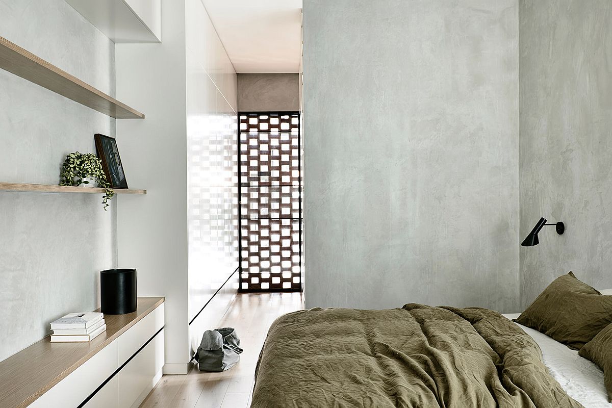 Modern minimal bedroom with gray walls and ample natural light on he upper level