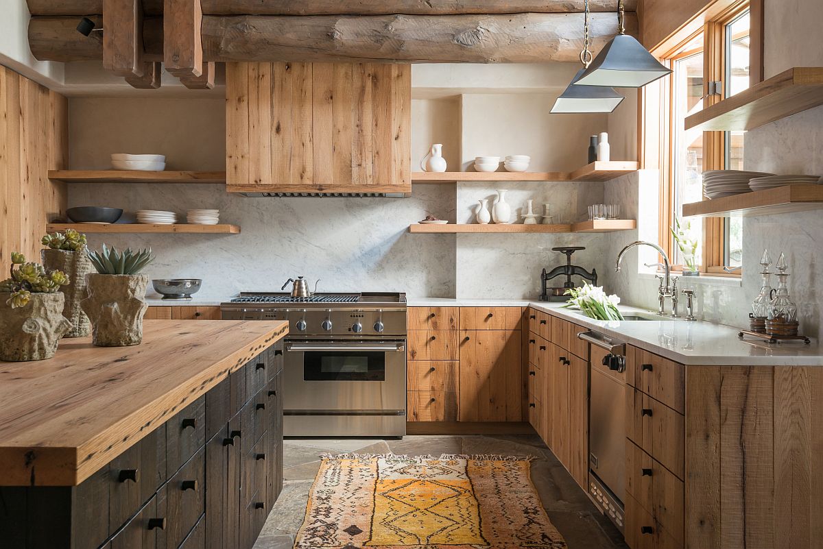 Modern practicality coupled with rustic elements like wooden ceiling beams and woodsy cabinets in the kitchen