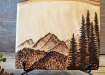 Mountain and trees burned on wood