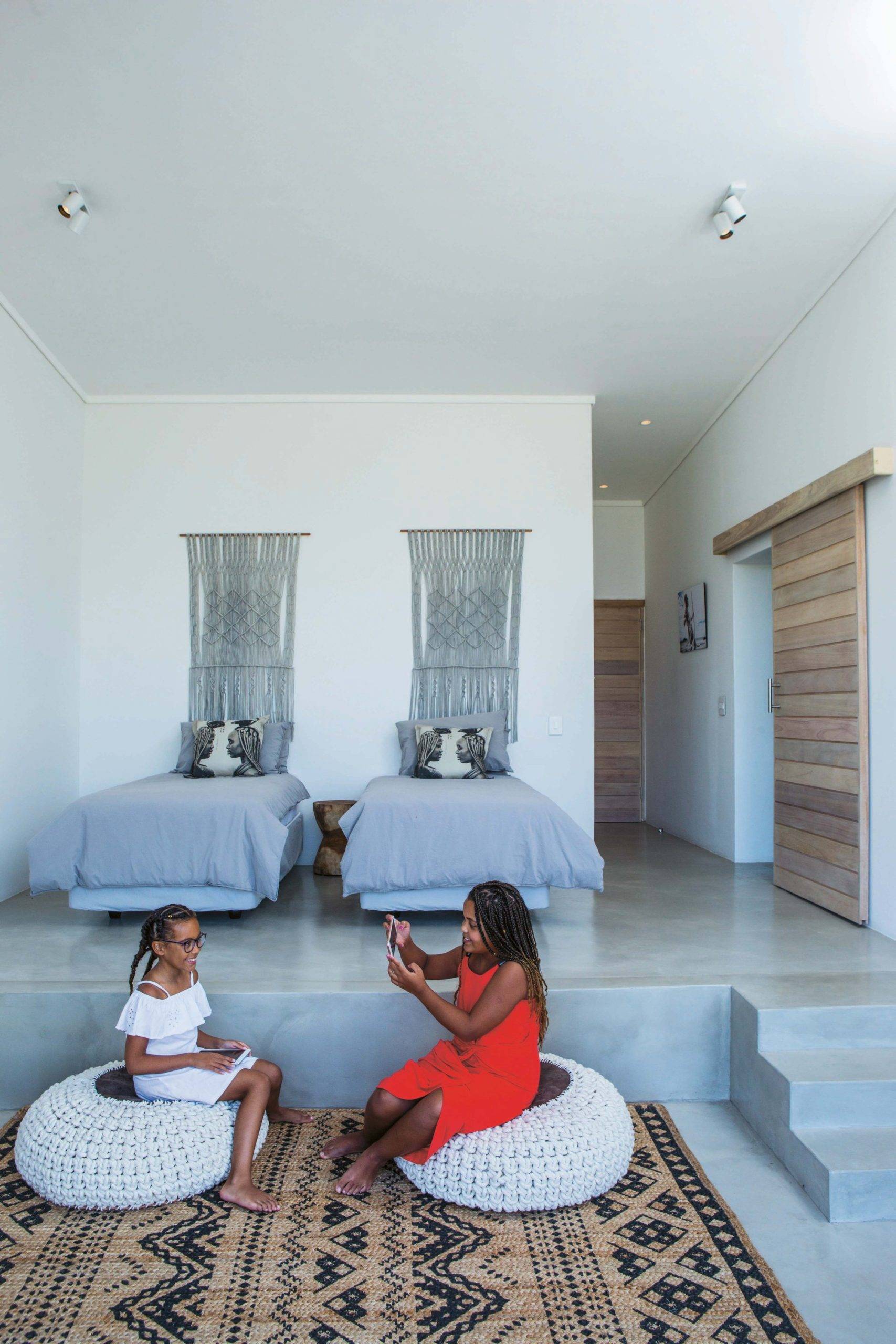 Multi-level interior of the home with neutral hues and rug that ushers in pattern