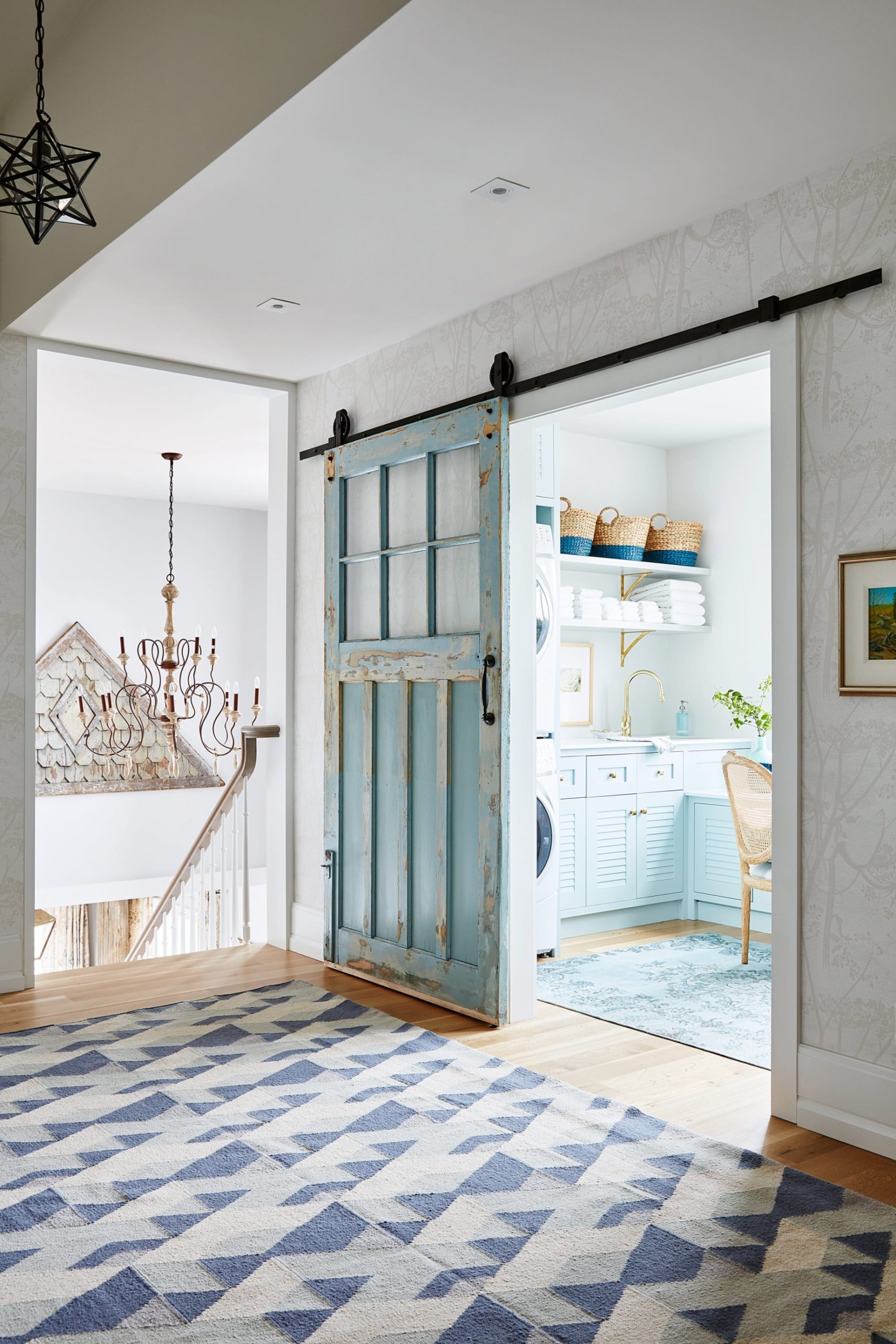 Old blue sliding door and chandelier with light bulbs