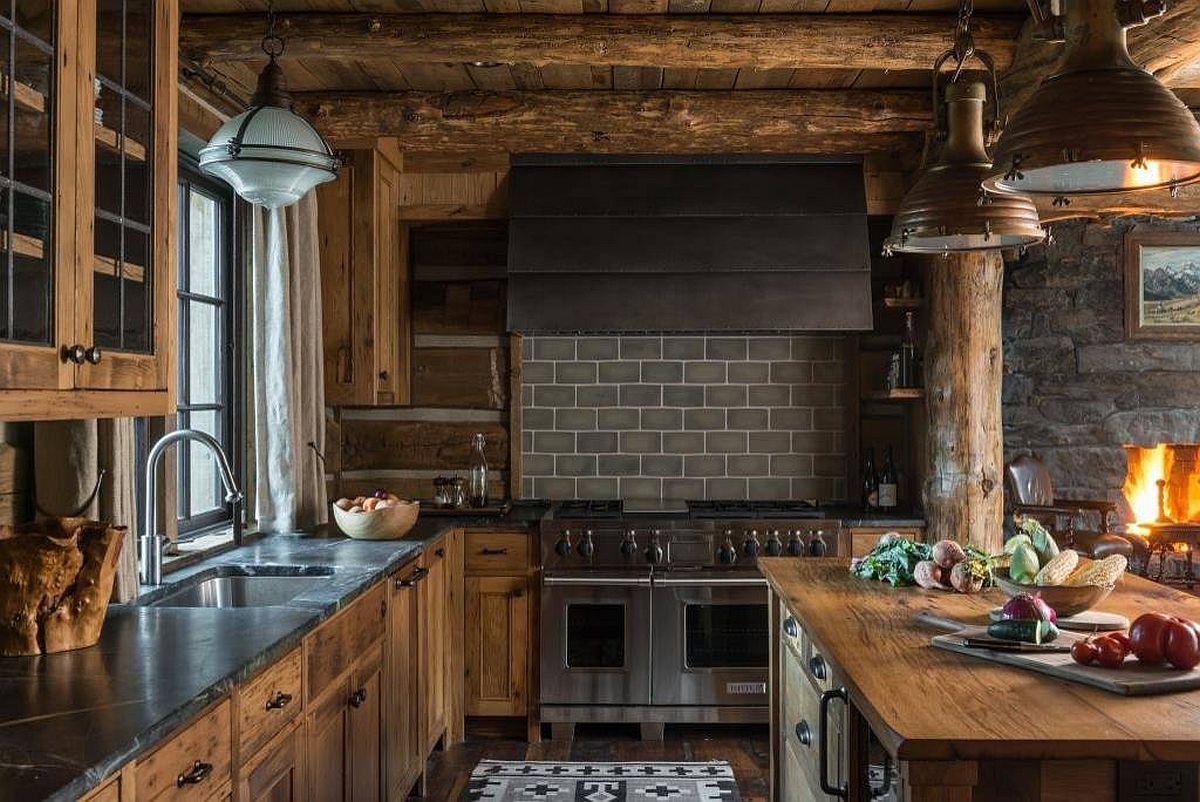 Picture-perfect rustic kitchen with a fireplace, stone coutertops and a cozy ambiance