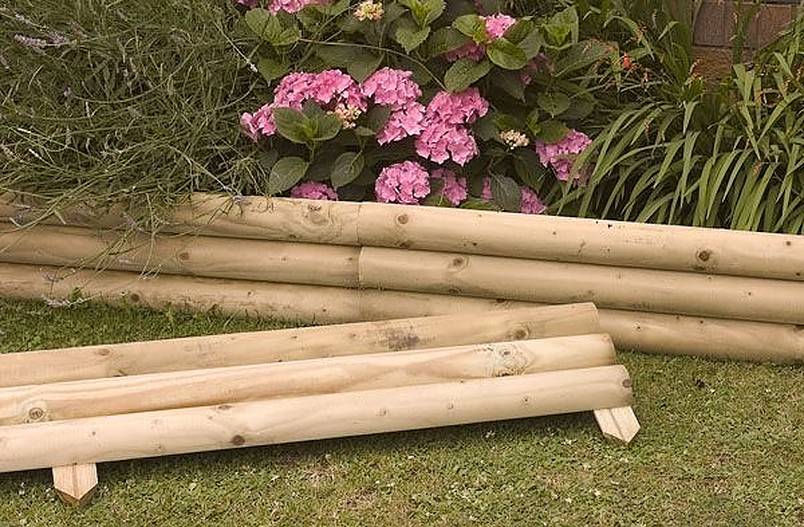 Pink flowers enclosed in a wood edging