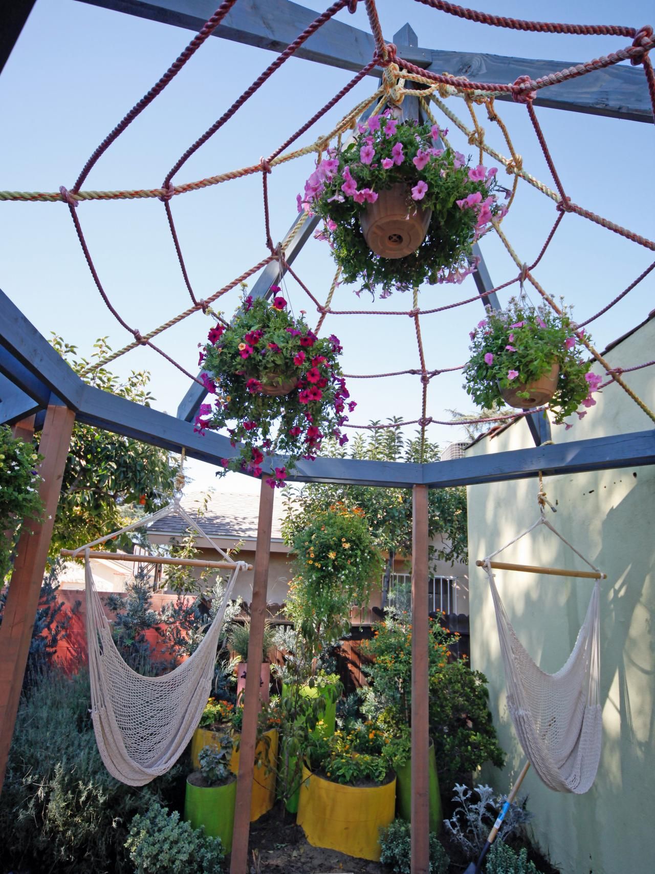 Potted flowers hanging in webbed ropes