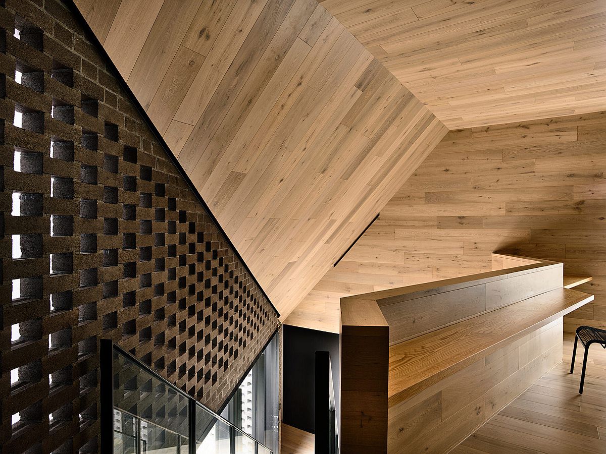 Sculptural staircase leading to the upper level with a calming study nook