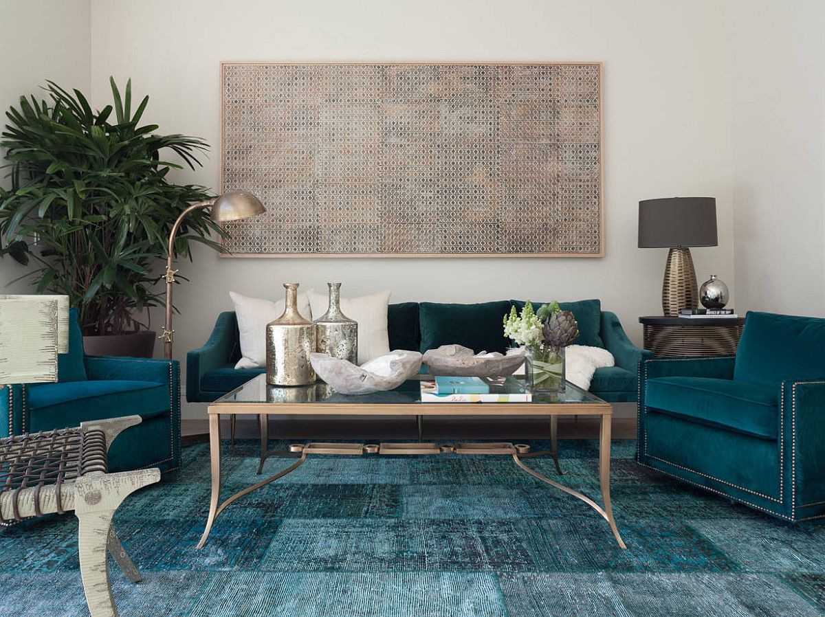 Sofas, rug and other accents add shades of deep blue and teal to the spacious modern living room