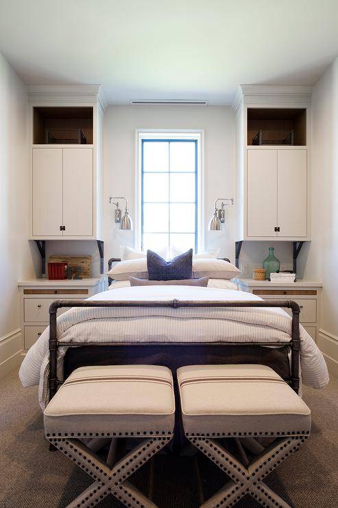 cupboards over nightstands in bedroom seats at end of bed window in middle