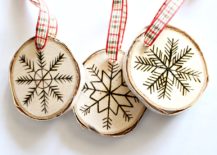 Three carved rounded Christmas ornaments with ribbon