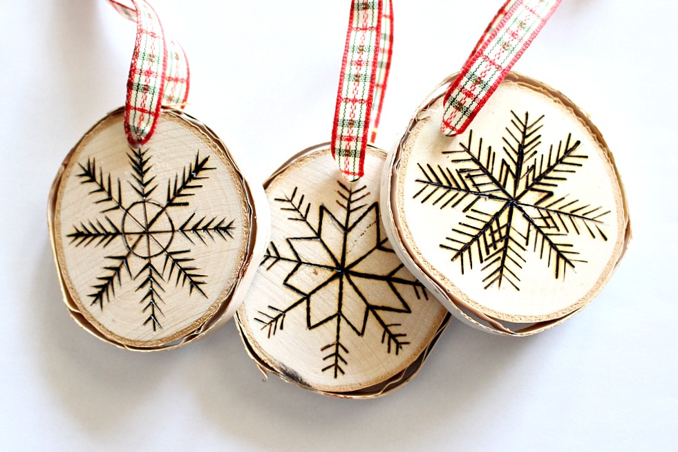 Three carved rounded Christmas ornaments with ribbon