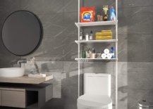 Three-layer adjustable shelf hooked from ceiling to wall in a gray tone bathroom with round mirror