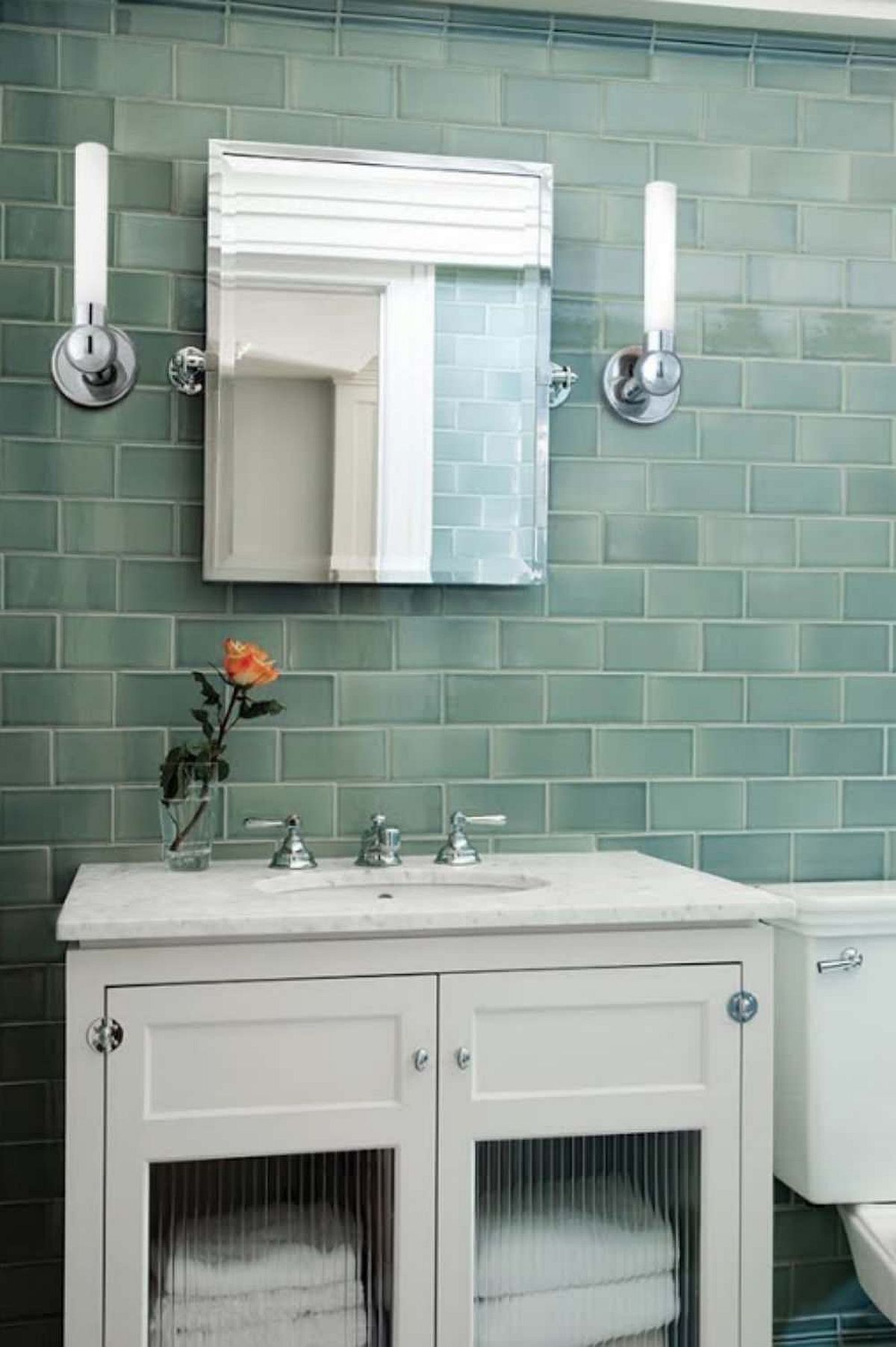 Tiles in green for the contemporary bathroom with white vanity and smart lighting