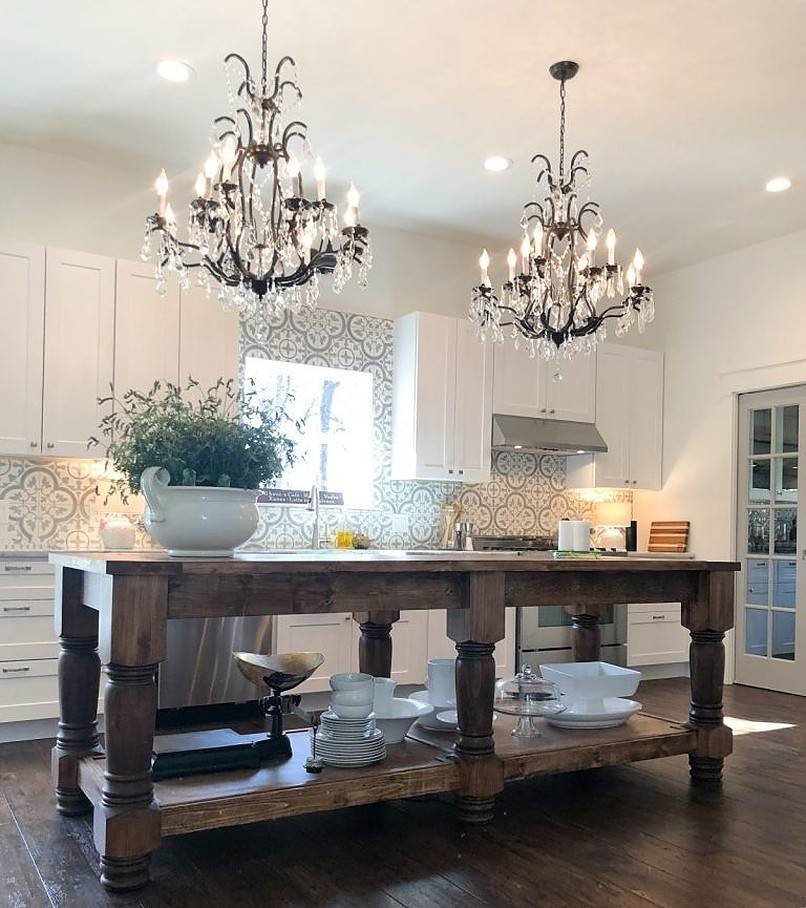 Two chandeliers above a table