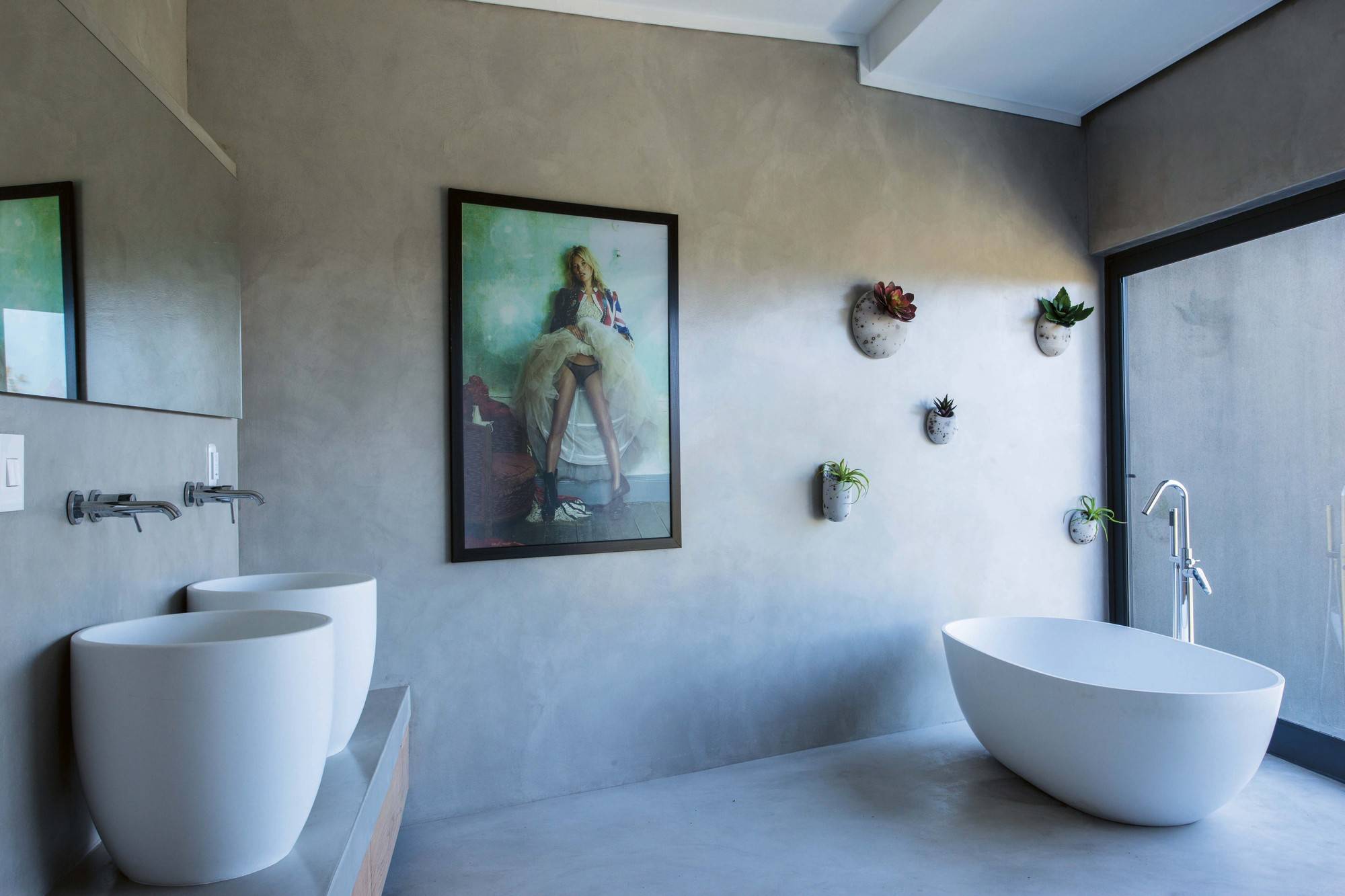 Wall-mounted plants inside the bathroom with polished, spa-inspired look