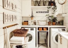 White laundry room with vintage decorations, plants and hanging weighing scale