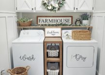 White laundry room with wreath and wicker baskets