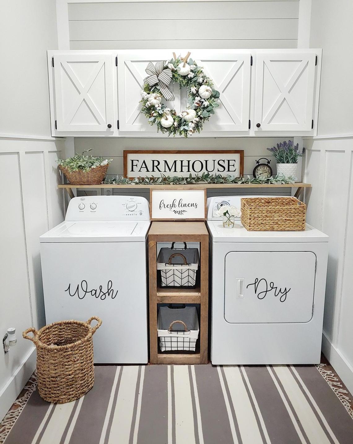 White laundry room with wreath and wicker baskets