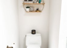White toilet with black candle on top