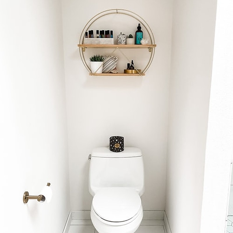 White toilet with black candle on top