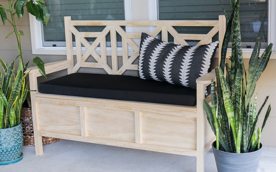 wooden bench surrounded by potted plants