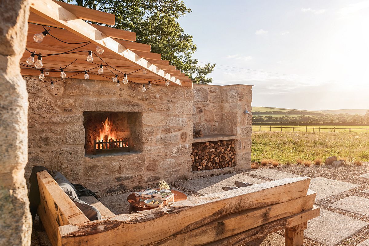 Wooden pergola structure coupled with stone walls create a relaxing and comfortable hangout outdoors