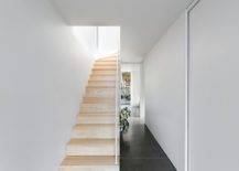 Wooden-staircase-brings-warmth-and-elegance-to-the-white-interior-of-the-home-56391-217x155