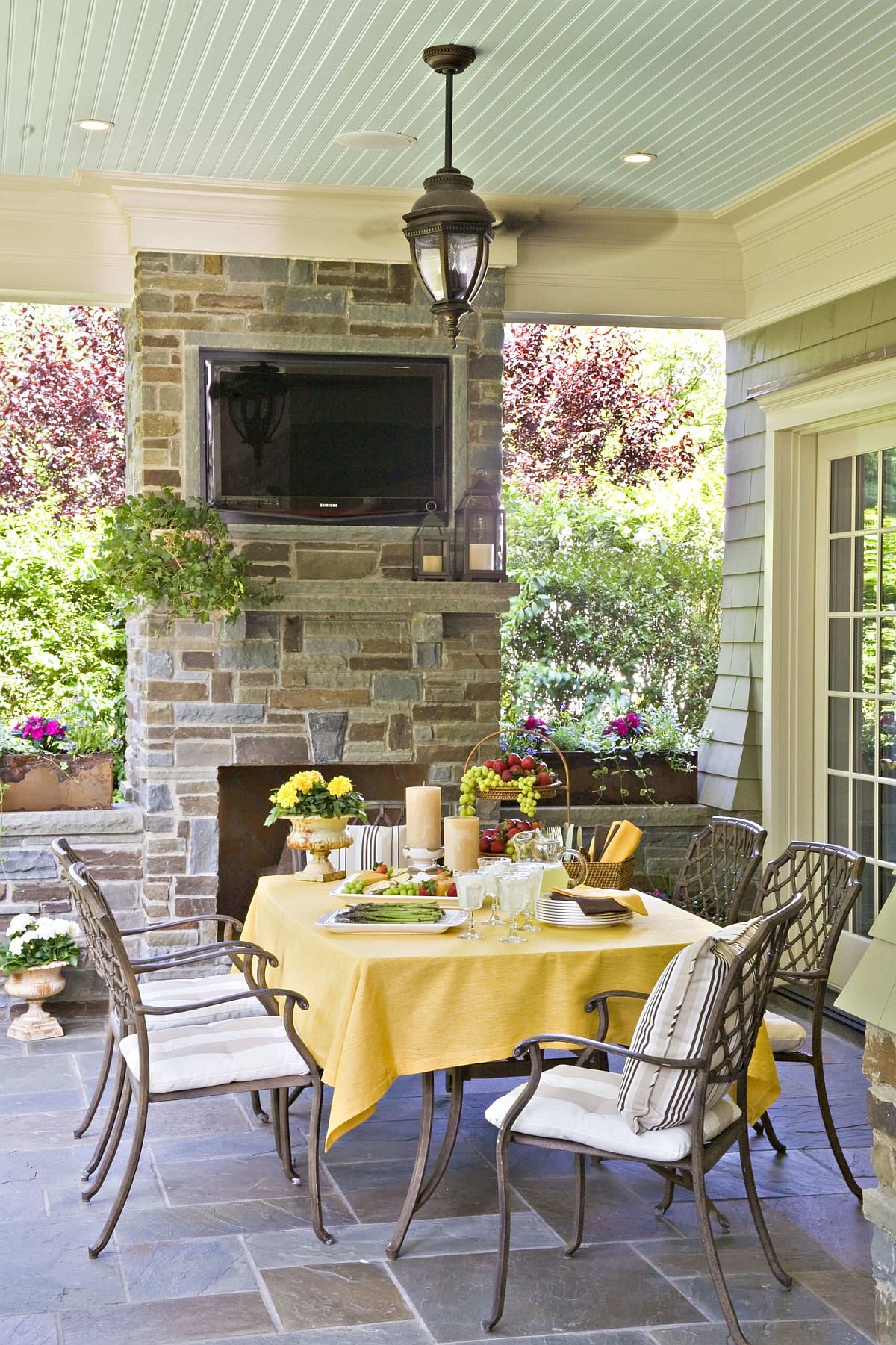 Yellow able cloth along with accents for the outdoor dining table