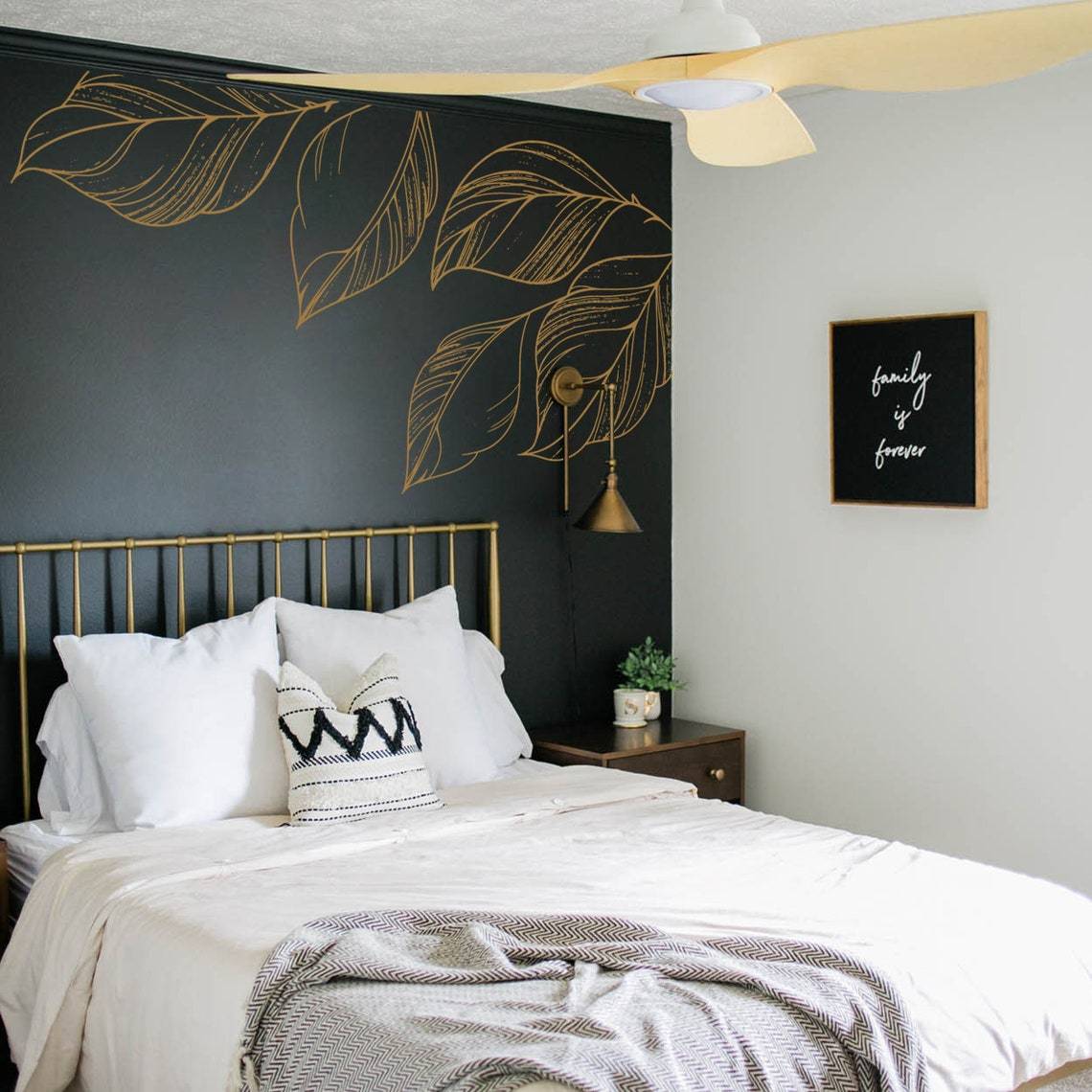 gold leaf accents on black bedroom wall