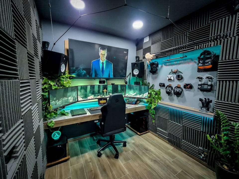 sound proof gaming room with multiple screens and blue lighting