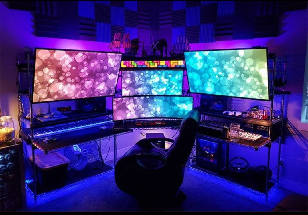 multiple screens and colored led lights for gaming setup