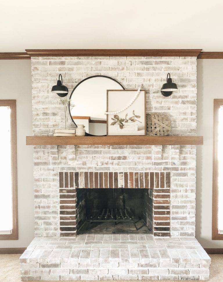 whitewashed brick fireplace with raw brick around fireplace insert