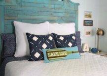 Bed with reclaimed headbord and blue and white pillows