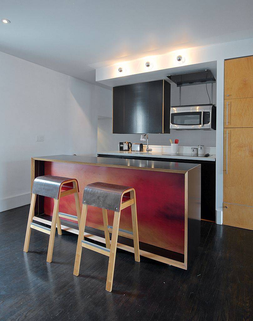 Bespoke kitchen island in wood and metal with bar stools that have a matching finish