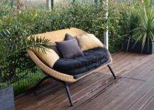 Cozy rattan sofa with cushions in tropical garden