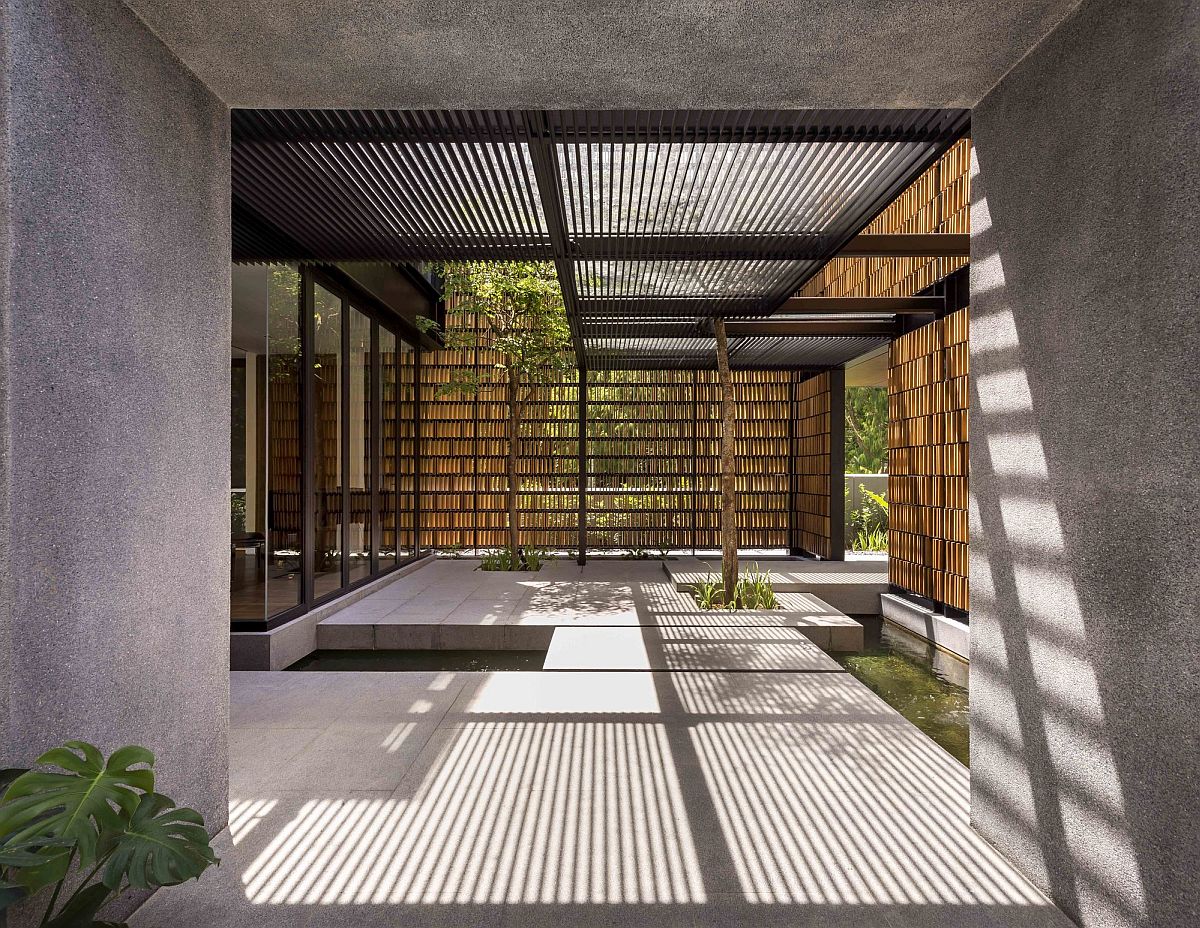 Custom timber screen covering the facade of the home offers ample privacy while allowing in filtered light