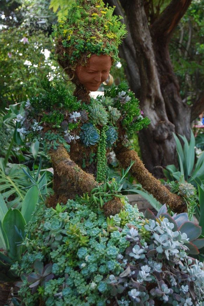 garden sculpture of woman made of terracotta and succulents