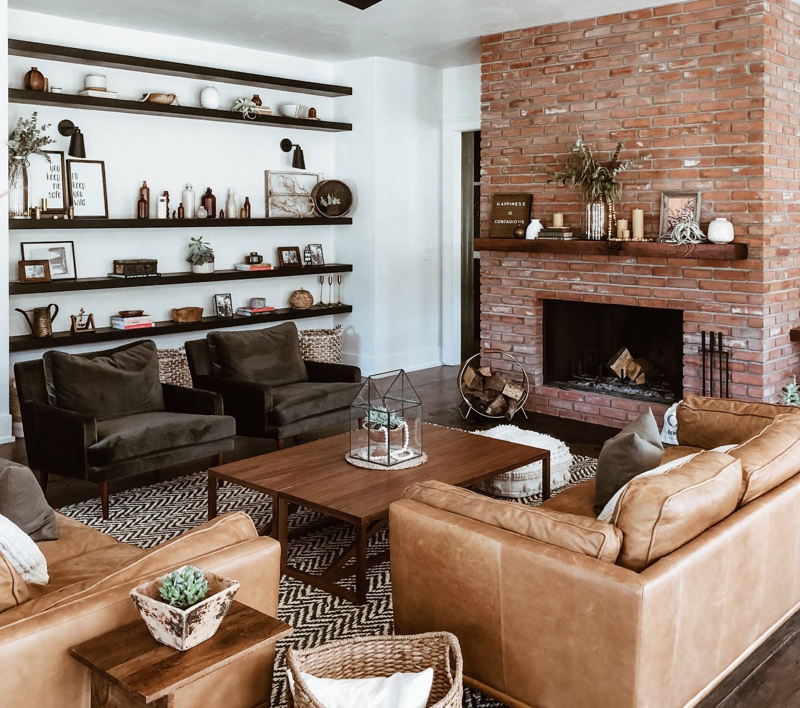 red brick fireplace in living room with leather couches
