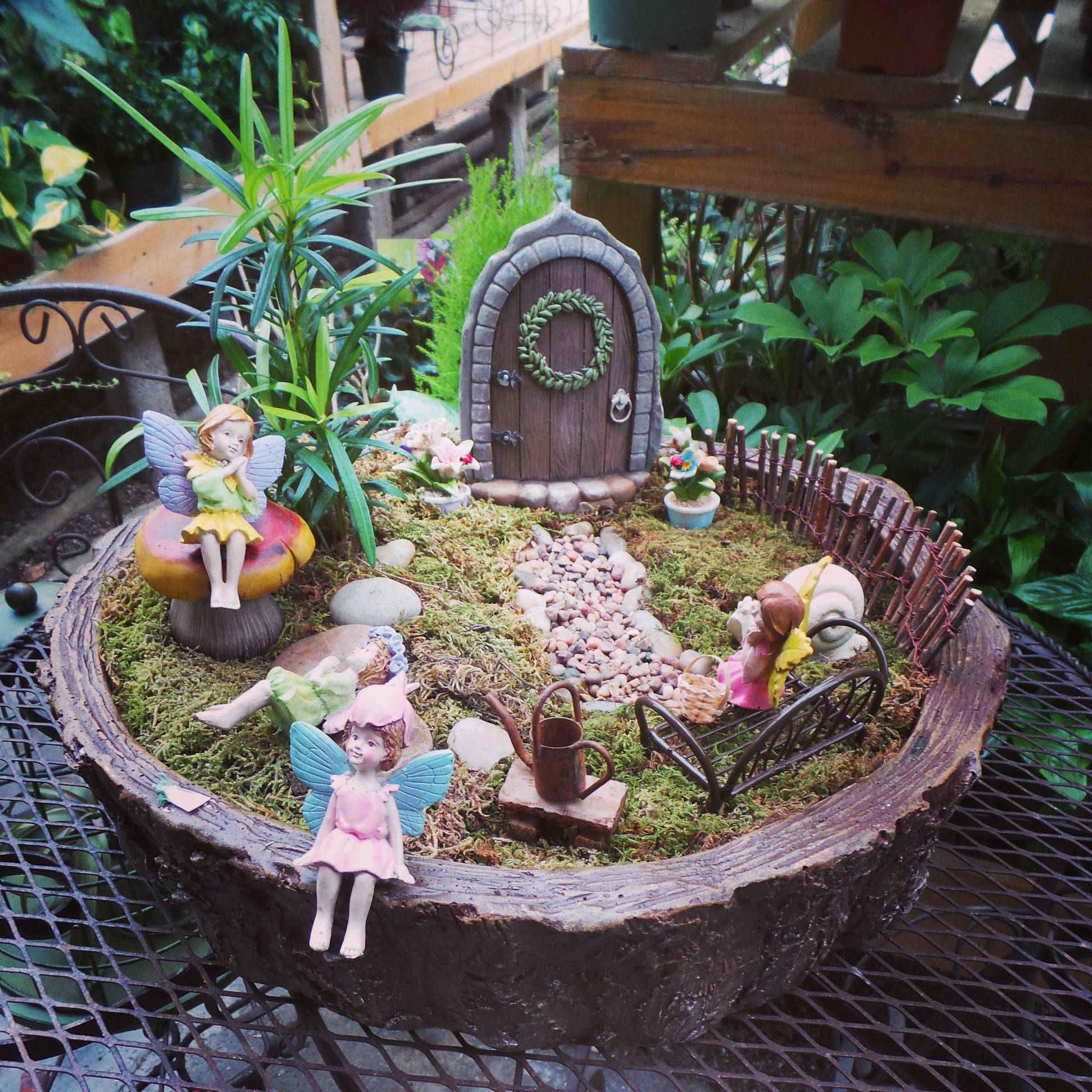 Fairies relaxing in miniature fairy garden